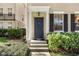 Townhome's front door entrance with columns and landscaping at 1054 Waterside Dr, Celebration, FL 34747