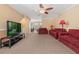 Bright living room featuring a flat-screen TV and comfortable seating at 1054 Waterside Dr, Celebration, FL 34747