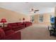 Spacious living room with red couches and carpeting at 1054 Waterside Dr, Celebration, FL 34747