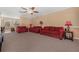 Spacious living room with plush red couches and a view into the dining area at 1054 Waterside Dr, Celebration, FL 34747