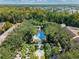 Community pool surrounded by lush landscaping and trees at 1054 Waterside Dr, Celebration, FL 34747