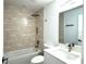 Updated bathroom with tub/shower combo and modern vanity at 1115 Munster Ct, Kissimmee, FL 34759