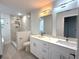 Modern bathroom with double vanity, quartz countertop and walk-in shower at 1115 Munster Ct, Kissimmee, FL 34759