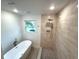 Elegant bathroom featuring a freestanding tub and walk-in shower at 1115 Munster Ct, Kissimmee, FL 34759