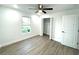 Spacious bedroom with ceiling fan, window, and closet at 1115 Munster Ct, Kissimmee, FL 34759