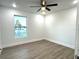 Well lit bedroom with ceiling fan and a large closet at 1115 Munster Ct, Kissimmee, FL 34759