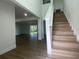 Bright and airy entryway with open floor plan and modern staircase at 1115 Munster Ct, Kissimmee, FL 34759