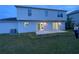 Two-story house rear view, gray siding, sliding doors to patio at 1115 Munster Ct, Kissimmee, FL 34759