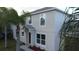 Two-story house with gray siding, brown garage door, and palm trees at 1115 Munster Ct, Kissimmee, FL 34759