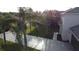 Two-story house with gray siding, brown garage door, and palm trees at 1115 Munster Ct, Kissimmee, FL 34759