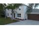 Two-story house with gray siding, brown garage door, and palm trees at 1115 Munster Ct, Kissimmee, FL 34759