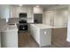 Modern kitchen with stainless steel appliances and island at 1115 Munster Ct, Kissimmee, FL 34759
