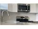 Stainless steel range and microwave in modern kitchen at 1115 Munster Ct, Kissimmee, FL 34759