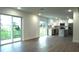 Open concept kitchen and living area with modern appliances and wood-look flooring at 1115 Munster Ct, Kissimmee, FL 34759
