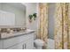 Bathroom with single vanity, shower/tub combo, and gold accents at 1778 Three Bars Rd, Kissimmee, FL 34744