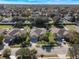 Aerial view of a residential neighborhood, showcasing houses with yards and tree-lined streets at 187 Osprey Lakes Cir, Chuluota, FL 32766