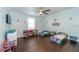 Mickey Mouse themed bedroom with twin beds and hardwood floors at 3140 Friars Cove Rd, Saint Cloud, FL 34772
