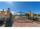 Ornate iron gates open to a brick paved driveway at 3140 Friars Cove Rd, Saint Cloud, FL 34772