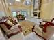 Spacious living room featuring a stone fireplace and large windows at 3140 Friars Cove Rd, Saint Cloud, FL 34772