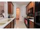 Modern kitchen with wood cabinets, black appliances, and ample counter space at 3344 Robert Trent Jones Dr # 40305, Orlando, FL 32835