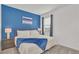 Bedroom with a king-size bed and a blue accent wall at 4481 Monado Dr, Kissimmee, FL 34746