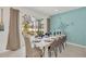 Dining room with a long table, gray chairs, and a view of the pool at 4481 Monado Dr, Kissimmee, FL 34746