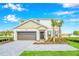 Two-story house with a gray and beige exterior, a brown garage door, and a paved driveway at 4481 Monado Dr, Kissimmee, FL 34746