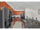 Modern kitchen with dark wood cabinets, black appliances, and granite countertops at 4481 Monado Dr, Kissimmee, FL 34746