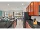 Modern kitchen with granite countertops, dark wood cabinets, and black appliances at 4481 Monado Dr, Kissimmee, FL 34746