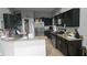 Well-equipped kitchen featuring granite countertops and dark wood cabinets at 5570 Willow Bend Trl, Kissimmee, FL 34758