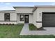 Modern house entrance with a dark door and walkway at 6870 Sw 129Th St, Ocala, FL 34473