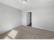 Simple bedroom with carpeted floors and a door to the hallway at 77 Pine Radl, Ocala, FL 34472