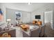 Bright living room featuring comfortable seating and a modern TV stand at 77 Pine Radl, Ocala, FL 34472