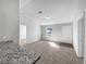 Bright living room with carpeted floors and access to other rooms at 77 Pine Radl, Ocala, FL 34472