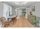 Light and airy dining area with hardwood floors, vintage buffet, and access to kitchen at 786 Antonette Ave, Winter Park, FL 32789