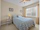 Bedroom with a queen bed, nightstands and window with blinds at 8336 Riverdale Ln, Davenport, FL 33896