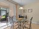 Bright breakfast nook with glass table and access to a patio at 8336 Riverdale Ln, Davenport, FL 33896
