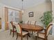 Formal dining room featuring an oval wood table and six chairs at 8336 Riverdale Ln, Davenport, FL 33896