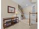 Elegant entryway with staircase, console table, and mirror at 8336 Riverdale Ln, Davenport, FL 33896