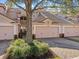 Two-story townhome with a two-car garage and lush landscaping at 8336 Riverdale Ln, Davenport, FL 33896
