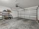Garage with shelving and an automatic garage door at 8336 Riverdale Ln, Davenport, FL 33896
