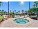 Community hot tub with palm trees and a wooden bench nearby at 8336 Riverdale Ln, Davenport, FL 33896