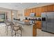 Modern kitchen with granite countertops and wood cabinets at 8336 Riverdale Ln, Davenport, FL 33896