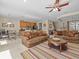 Spacious living room with comfortable seating and a view into the kitchen at 8336 Riverdale Ln, Davenport, FL 33896