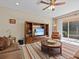 Relaxing living room with sliding glass doors and an entertainment center at 8336 Riverdale Ln, Davenport, FL 33896