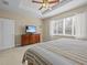 Main bedroom with king bed, dresser, and window at 8336 Riverdale Ln, Davenport, FL 33896