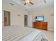 Main bedroom with king bed, dresser, and access to bathroom at 8336 Riverdale Ln, Davenport, FL 33896