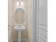 Small powder room with pedestal sink and round mirror at 8336 Riverdale Ln, Davenport, FL 33896