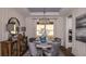 Elegant dining room with a round table, upholstered chairs, and a stylish chandelier at 851 Arbor Green Trl, St Cloud, FL 34771