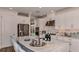 Bright and airy kitchen with white cabinetry, a large island, and stainless steel appliances at 851 Arbor Green Trl, St Cloud, FL 34771